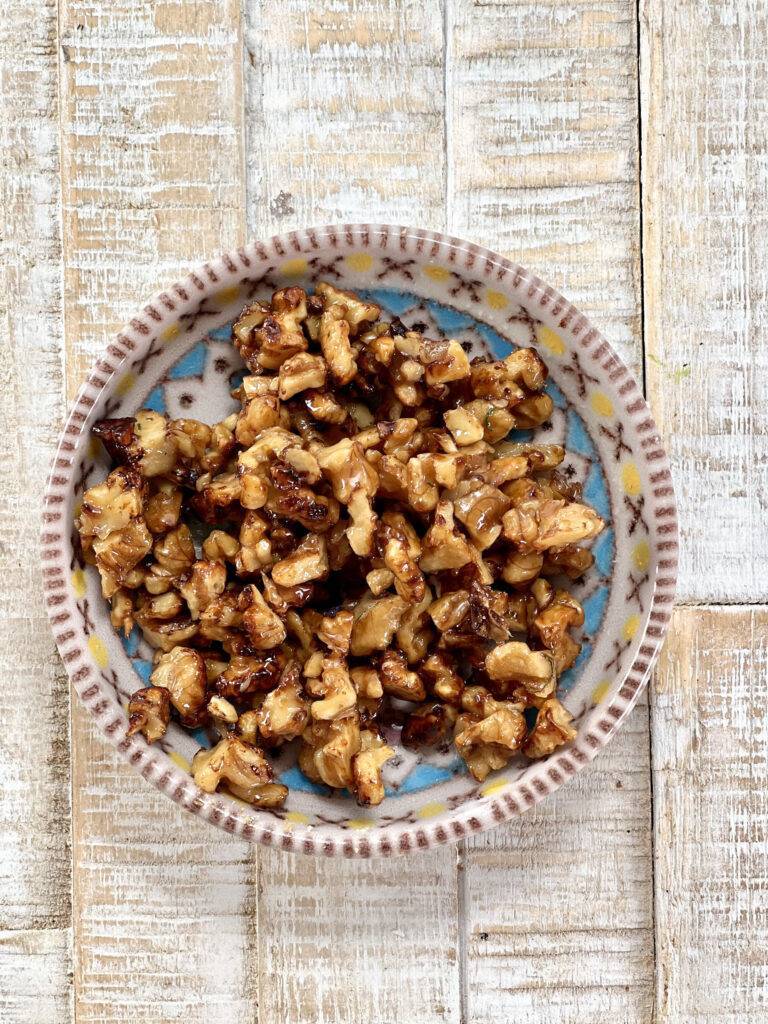 Little ceramic bowl with caramelised walnuts