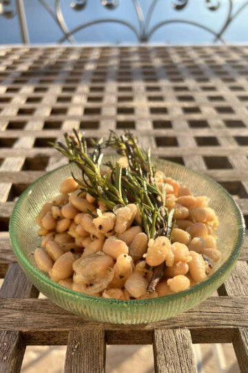 Beans with rosemary in bowl