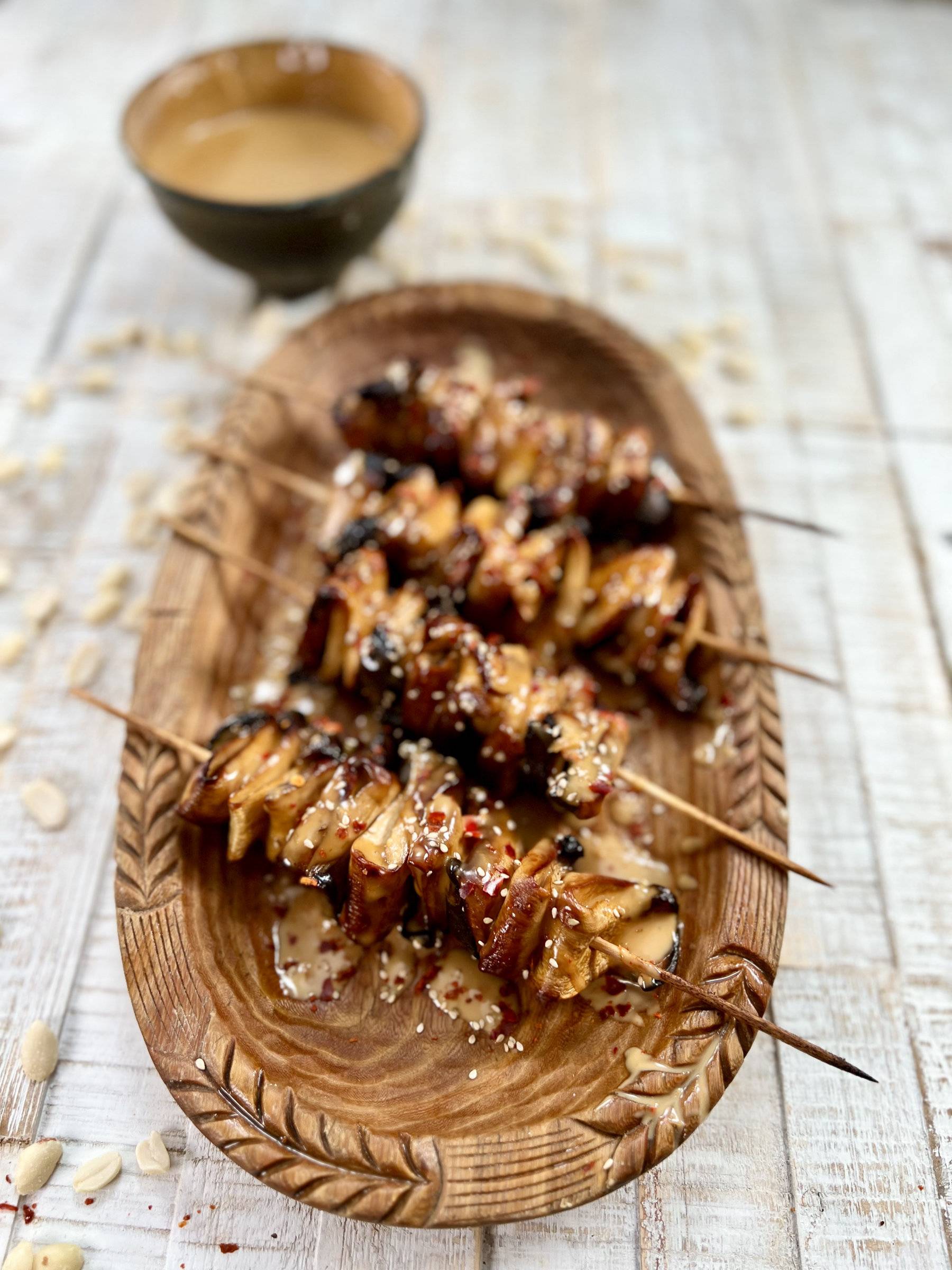 Vegan skewers served with peanut sauce and chilli flakes