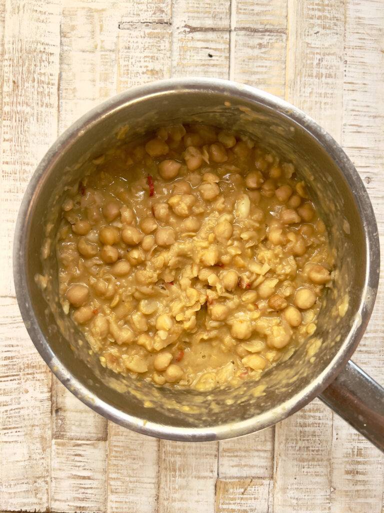 Finished thickened chickpea stew in a stainless steel pot