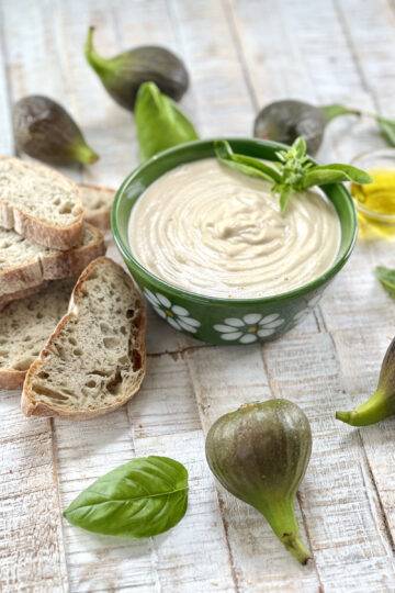 A bowl of vegan cashew cream cheese with figs and bread