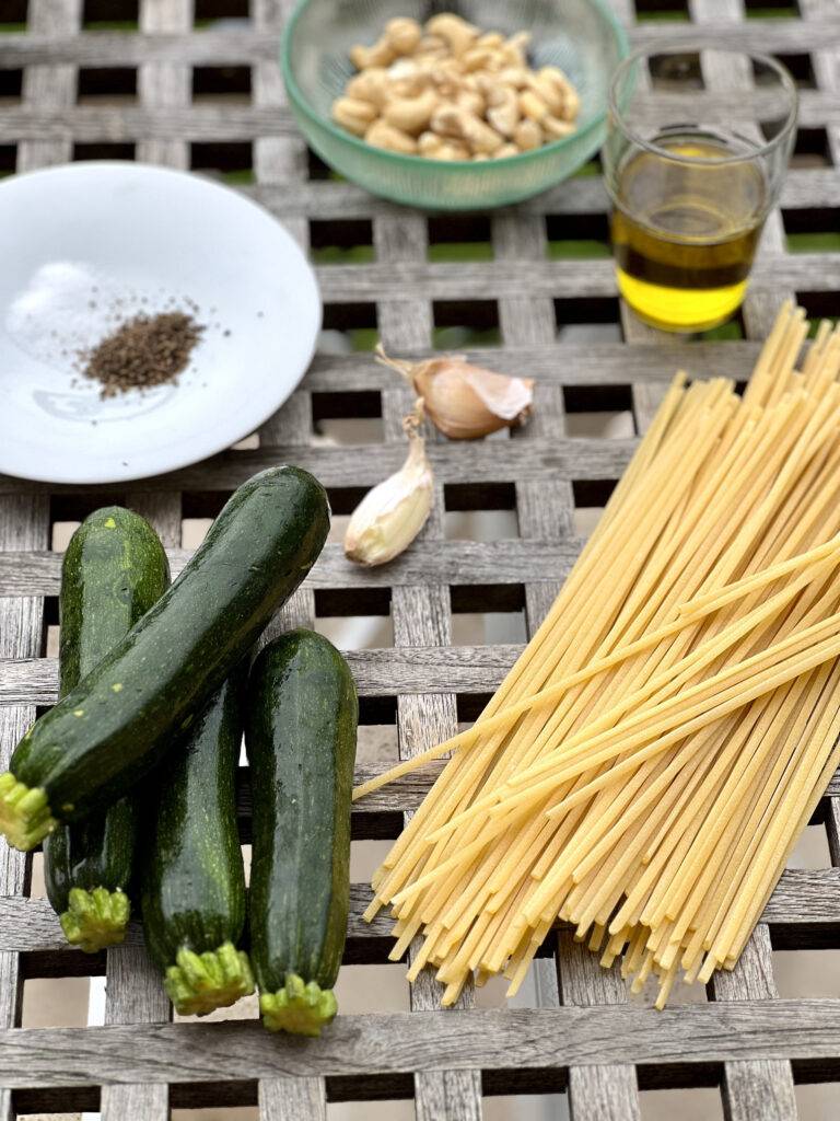 Fresh, beautiful ingredients for Spaghetti alla Nerano on a wooden table