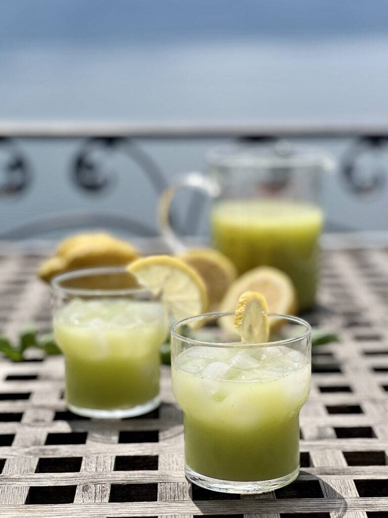 Two beautifully garnished servings of basil lemonade