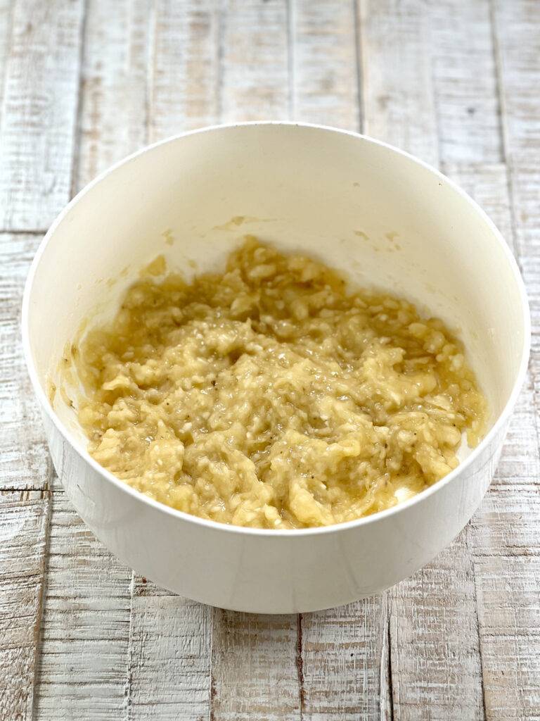 Mashed bananas in a white bowl