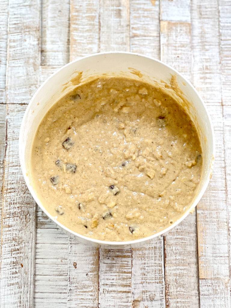 The finished dough for vegan banana bread in a white bowl