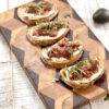 A beautiful wooden board with fig crostini