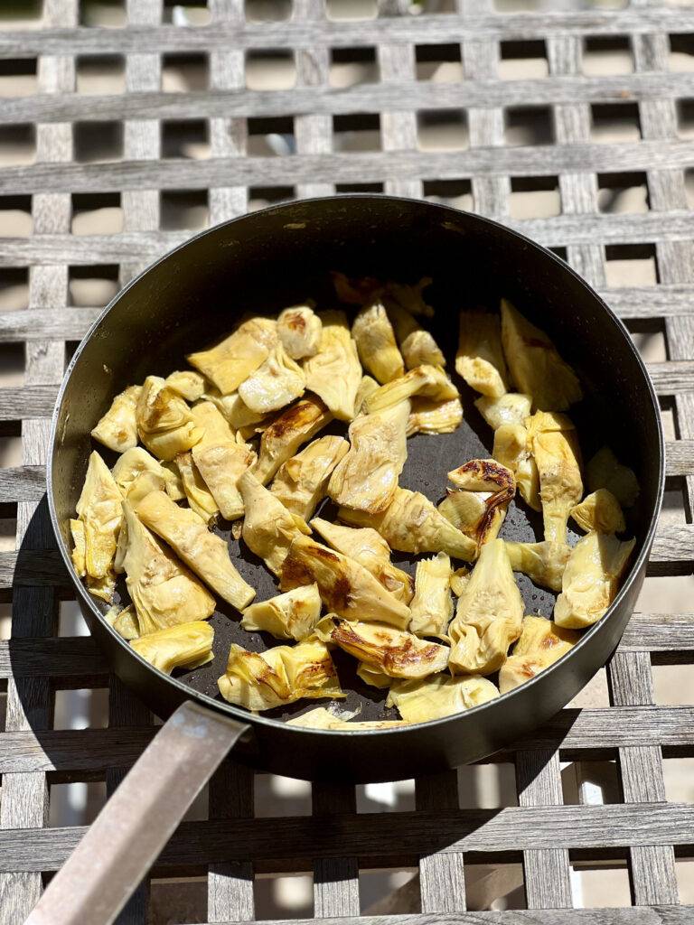 Seared artichokes in pan 