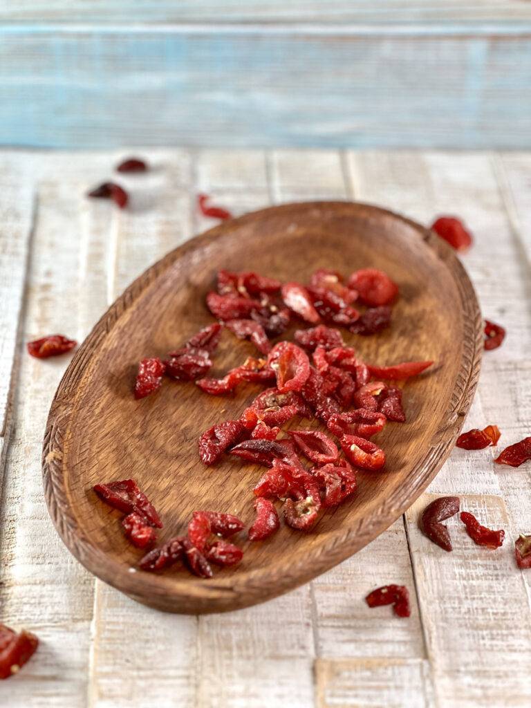Dried rose hips in a wooden bowl