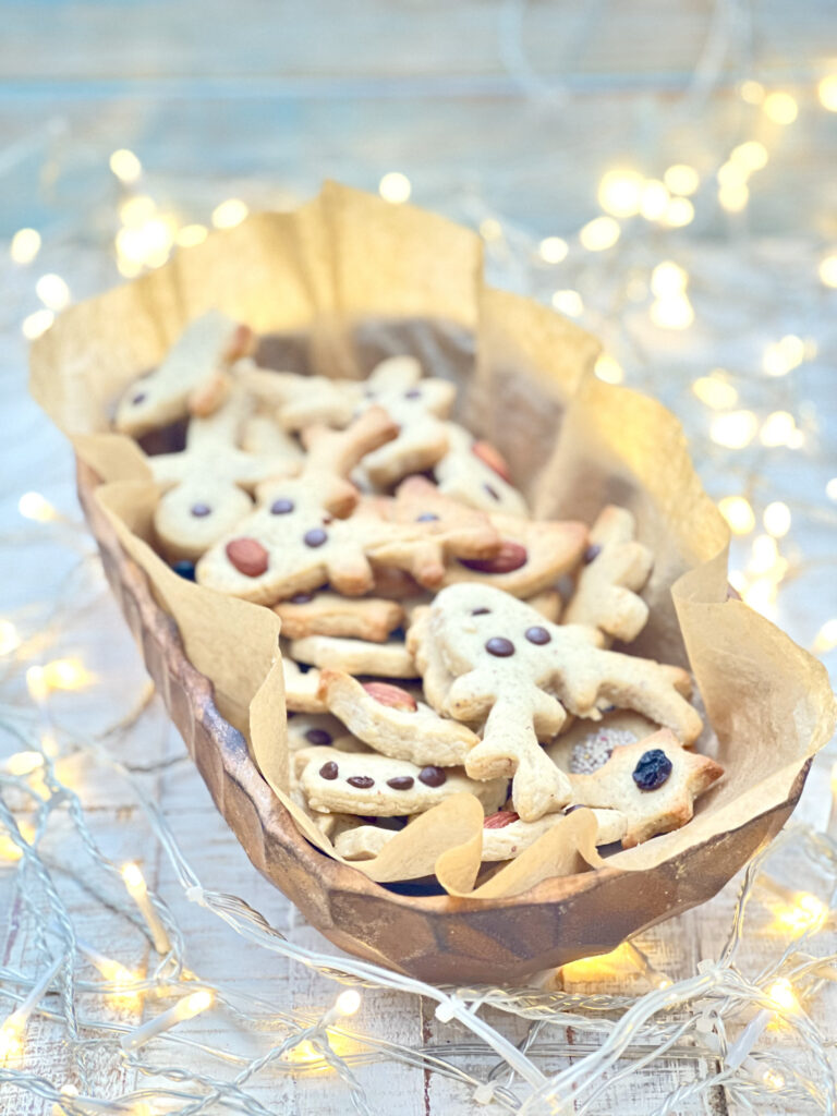 Garnished vegan shortbread cookies in Christmas lighting