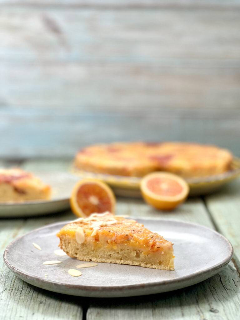 A close-up profile shot from a slice of blood orange olive oil cake