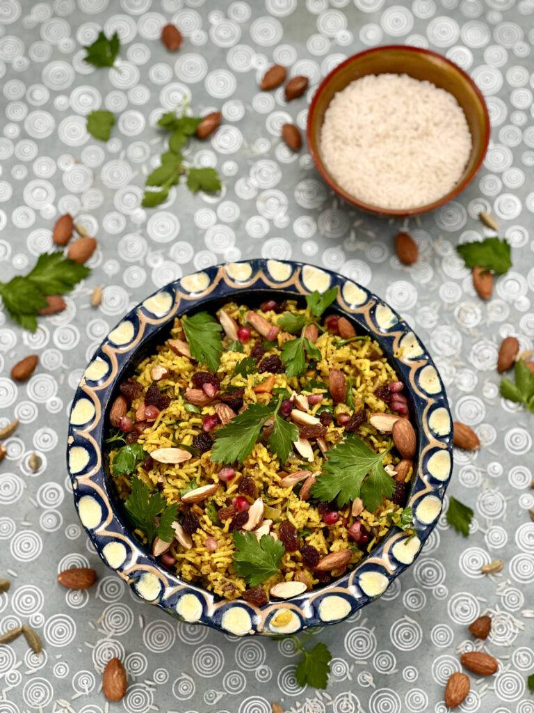 A beautiful ceramic bowl with colorful, garnished vegan pilaf rice