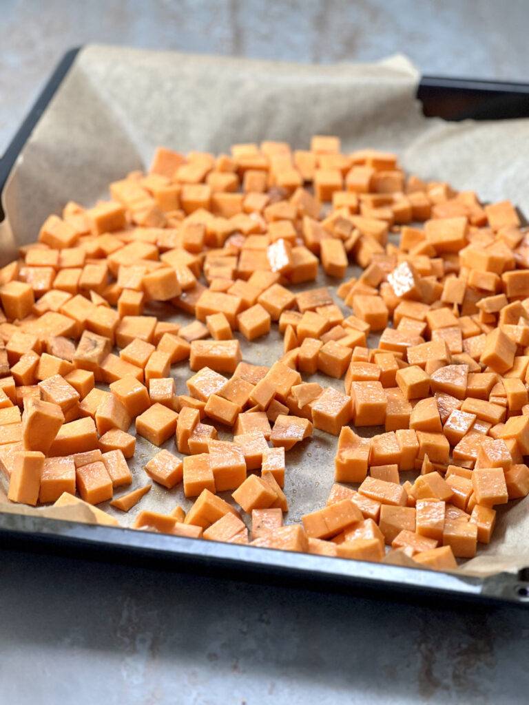 Sweet potatoes diced on baking tray