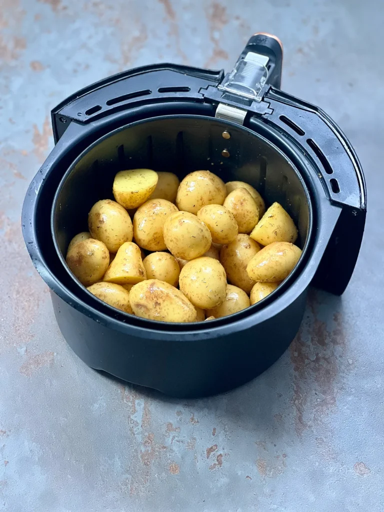 Potatoes in a black air fryer