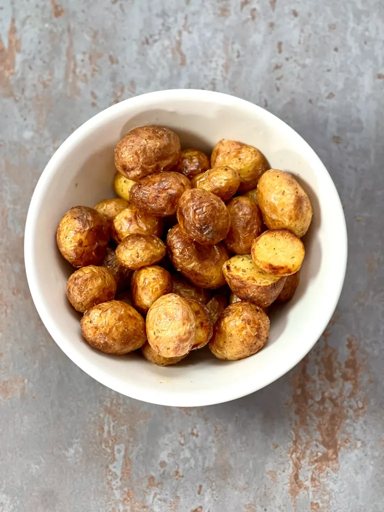 Crispy potatoes from the air fryer in a white ceramic bowl
