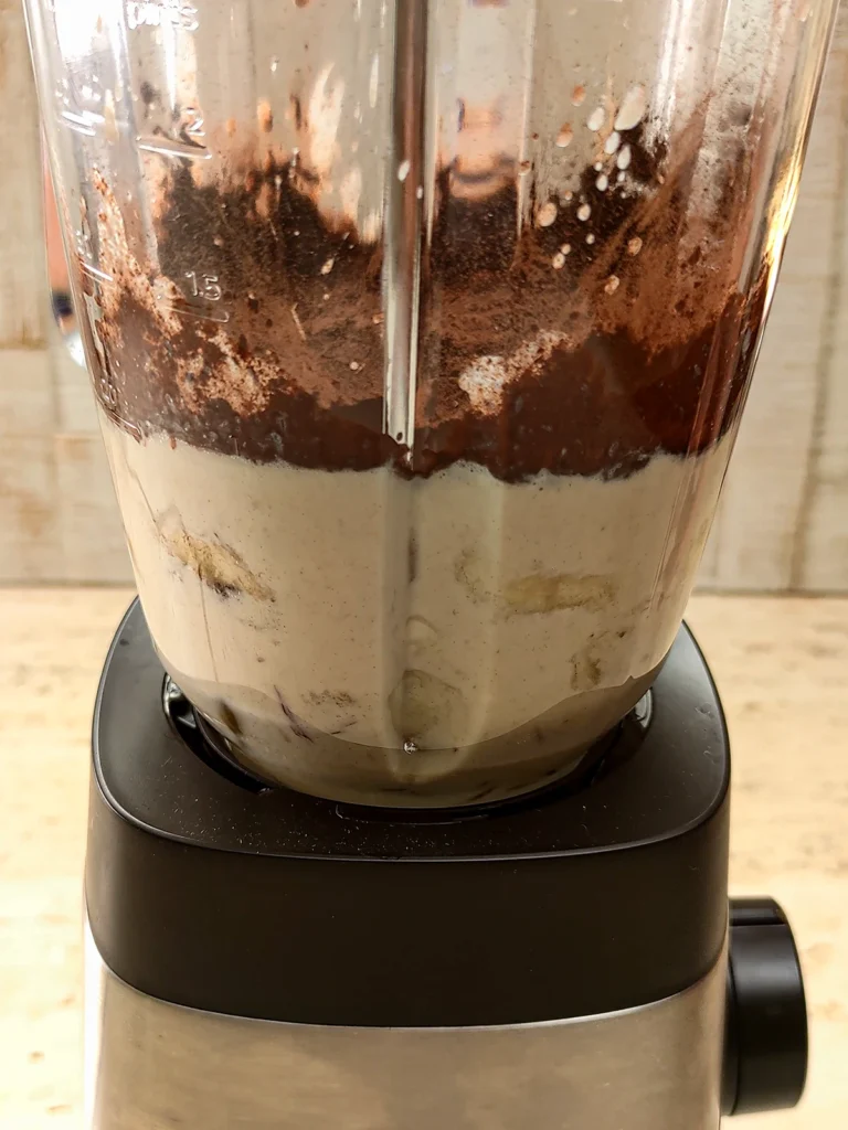 All ingredients for chocolate popsicles are in the blender.