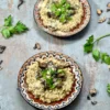 A bird's eye angle of two served plates of creamy vegan mushroom risotto w