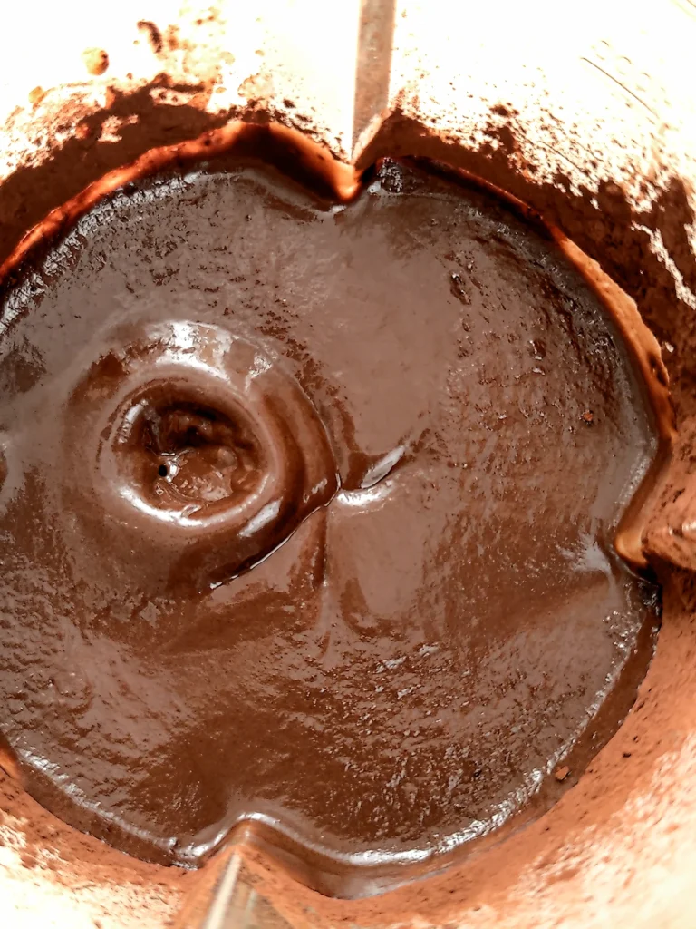 A close look into the blender at the pureed chocolate mixture.