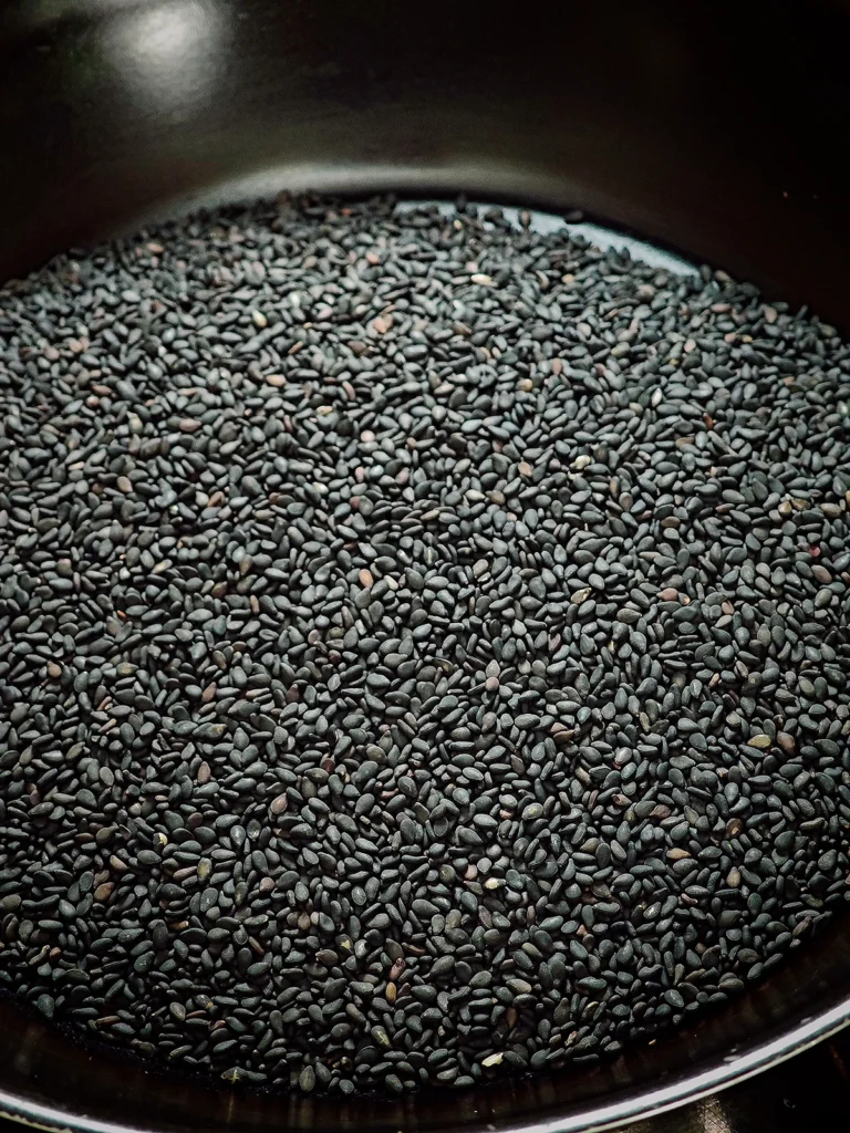 Close look at black sesame in a pan.