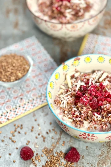 Two bowls of served buckwheat porridge, beautifully presented on a stone plate