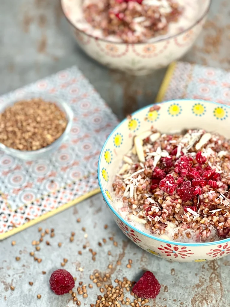 Two bowls of served buckwheat porridge, beautifully presented on a stone plate