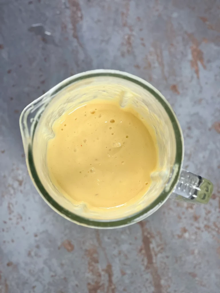 Blended, creamy mango lassi in the blender