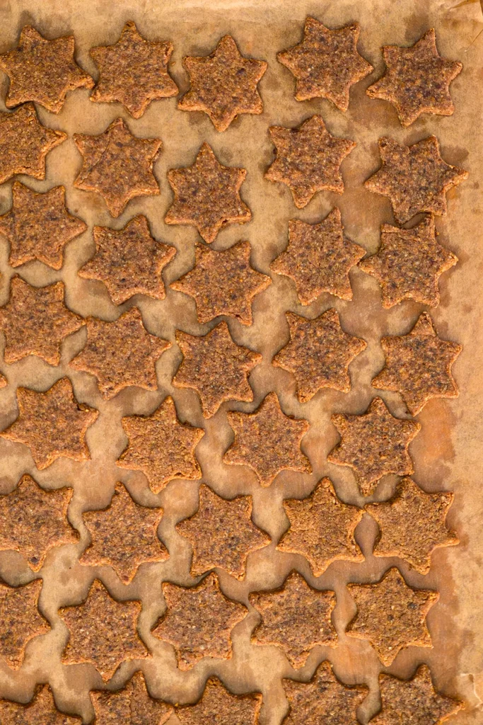 Cinnamon Star Cookies after baking on baking paper.