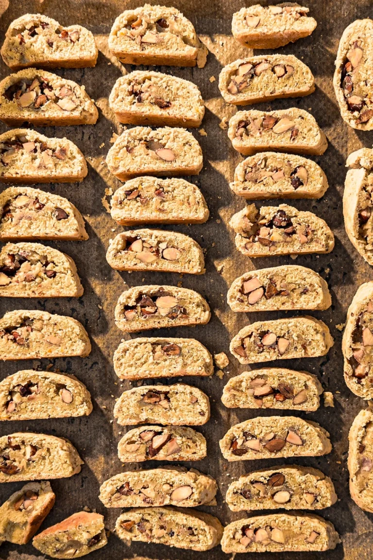 A look upon the baking tray with the slices of vegan almond biscotti with orange and marzipan.