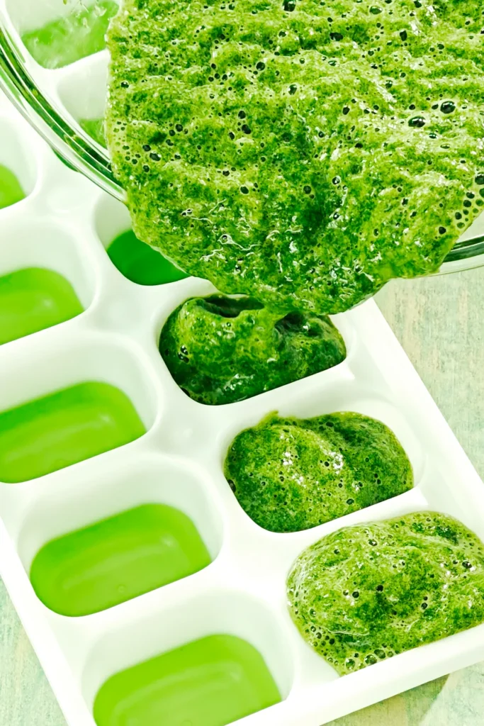 The wild garlic puree is poured into the ice cube tray by the blender.