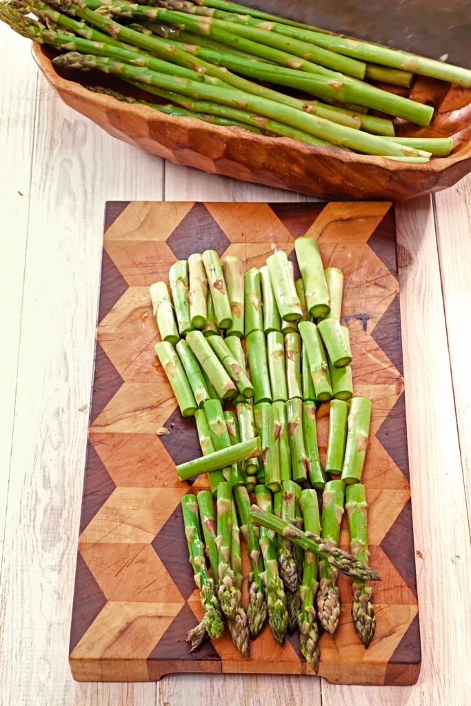 The fresh green asparagus is cut into pieces.