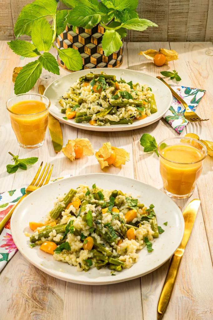 One-pot asparagus risotto served on plates on a beautifully set table.