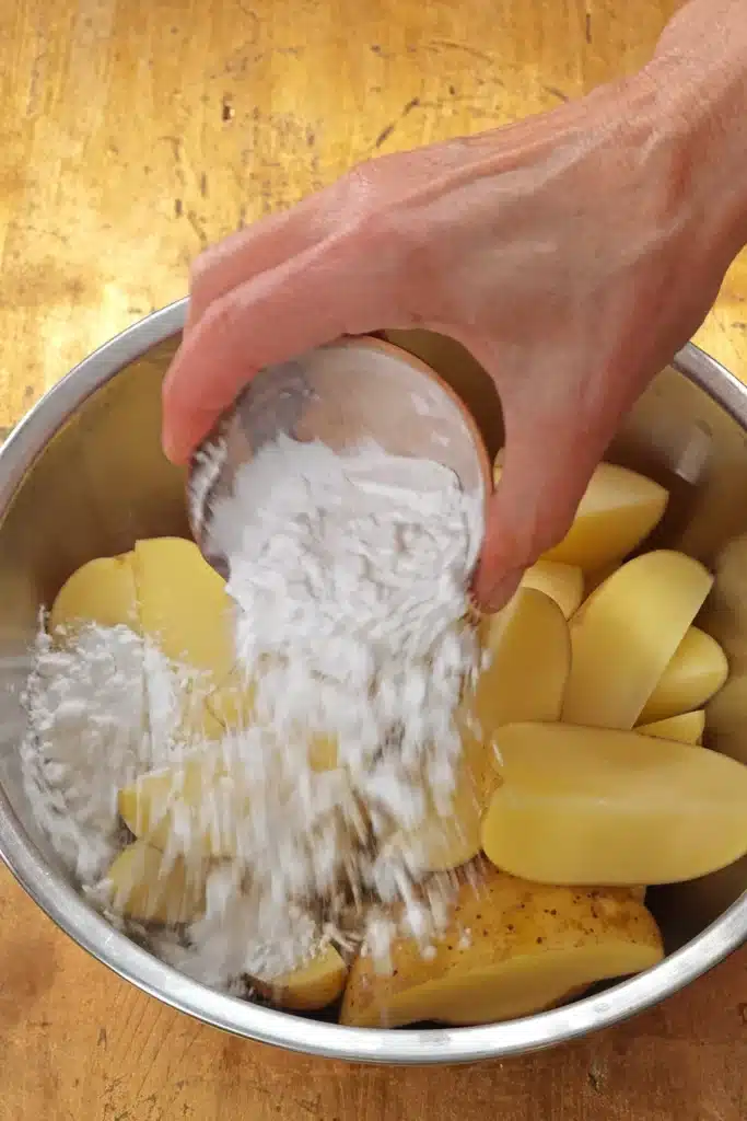 Sprinkle the starch over the potato wedges.